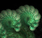 This unusual fractal render resembles a plump green caterpillar, the delicate growth of new ferns, or even a wave cresting. Look closely — it's edged with baby spirals.